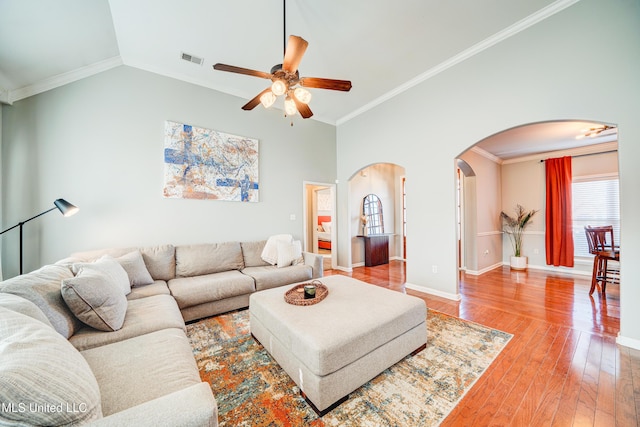 living room featuring lofted ceiling, hardwood / wood-style floors, ornamental molding, and ceiling fan