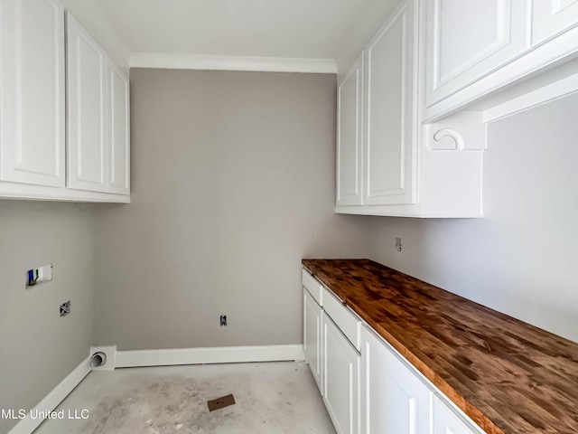 501 Harper Cv, Flowood, MS 39232 - laundry room with baseboards, cabinet space, electric dryer hookup, crown molding, and hookup for a washing machine