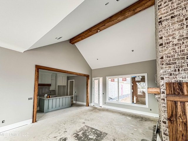 501 Harper Cv, Flowood, MS 39232 - unfurnished living room featuring baseboards, high vaulted ceiling, and beamed ceiling
