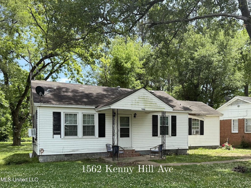 view of front of property with entry steps, a front yard, crawl space, cooling unit, and roof with shingles
