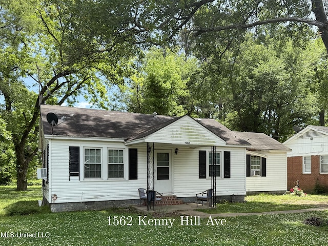 view of front of property with entry steps, a front yard, crawl space, cooling unit, and roof with shingles