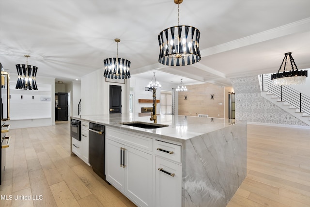 kitchen with light stone countertops, pendant lighting, white cabinets, and an inviting chandelier