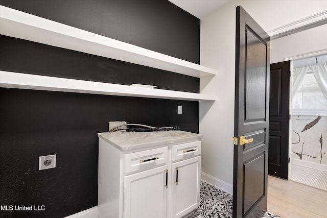 washroom with hookup for an electric dryer and light hardwood / wood-style floors