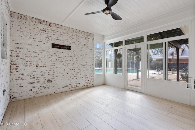 unfurnished sunroom featuring ceiling fan and wood ceiling