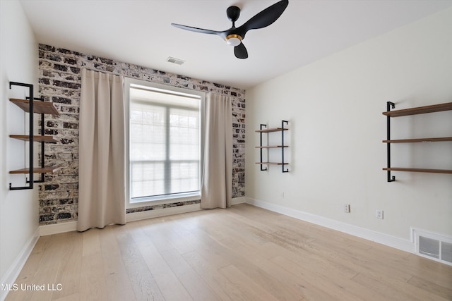 unfurnished room with ceiling fan and light wood-type flooring