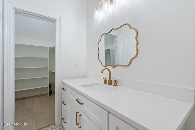 bathroom with hardwood / wood-style floors and vanity