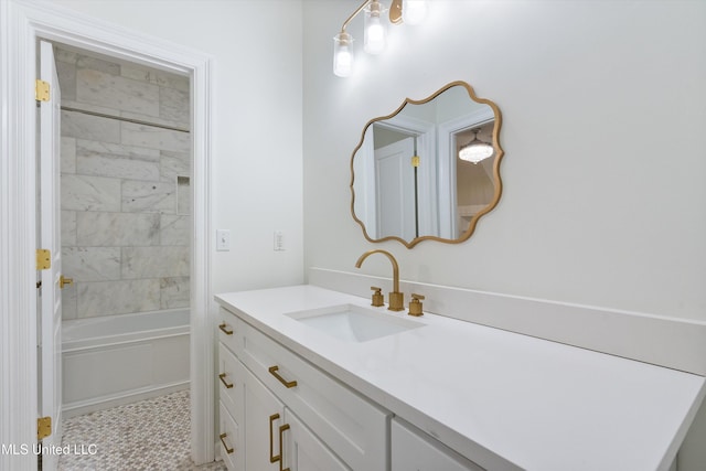 bathroom featuring tile patterned floors, vanity, and tiled shower / bath