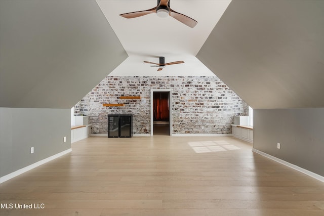 bonus room with light wood-type flooring, vaulted ceiling, and ceiling fan