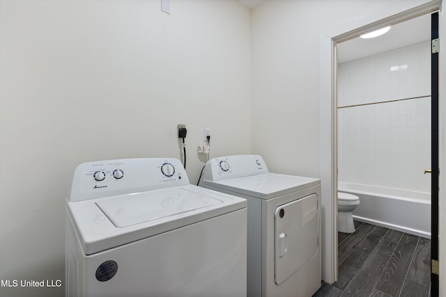 laundry area with washer and clothes dryer and dark hardwood / wood-style flooring