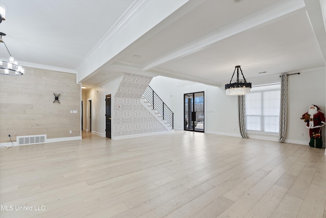 unfurnished living room with light wood-type flooring, crown molding, beamed ceiling, and an inviting chandelier