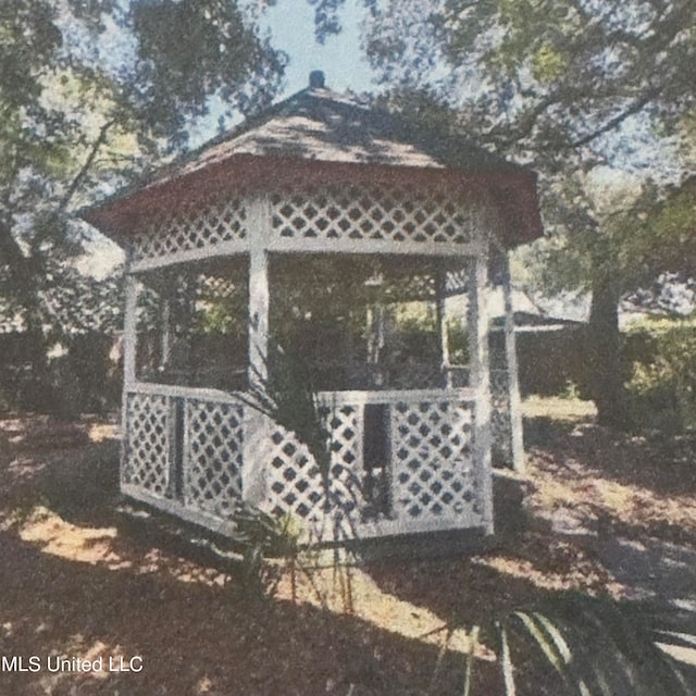 view of side of home featuring a gazebo