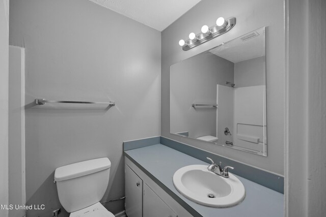 bathroom featuring visible vents, toilet, and vanity