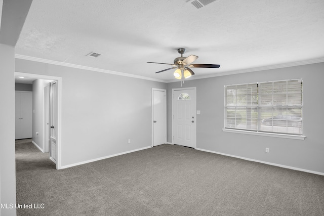 carpeted empty room featuring crown molding, baseboards, a ceiling fan, and a textured ceiling
