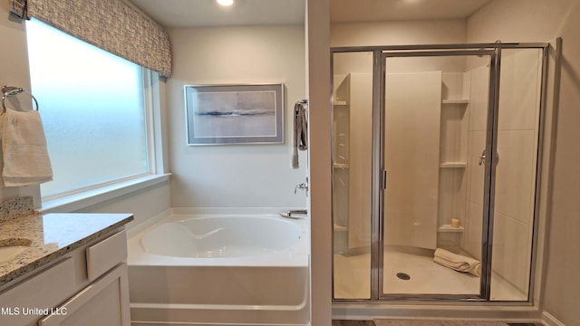 bathroom featuring vanity and separate shower and tub