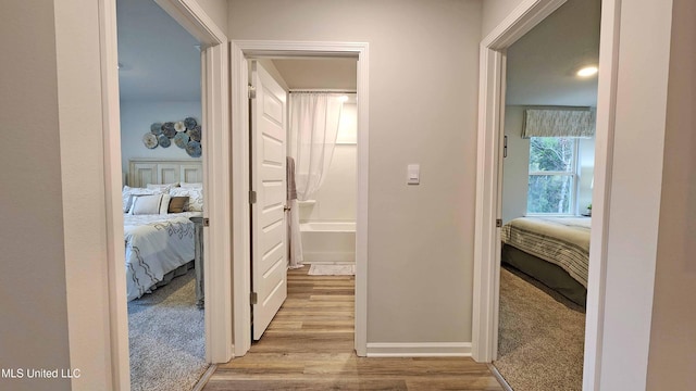 hallway with light hardwood / wood-style floors