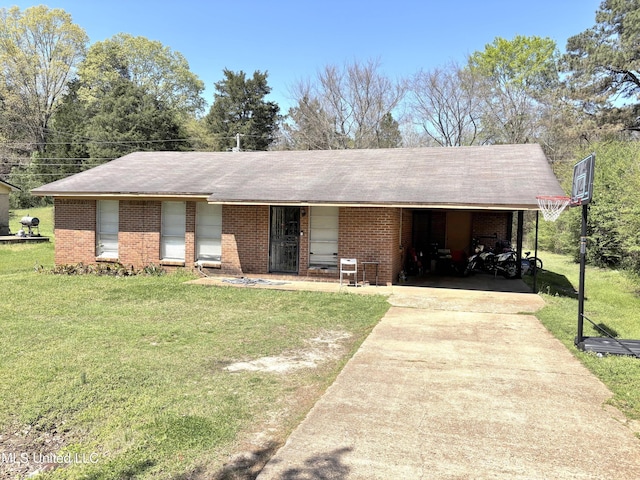 single story home featuring concrete driveway, a front yard, brick siding, and an attached carport