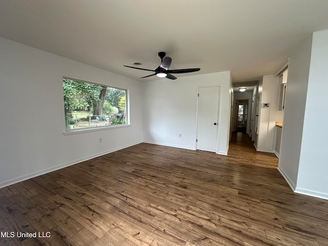 unfurnished room featuring ceiling fan and dark hardwood / wood-style flooring