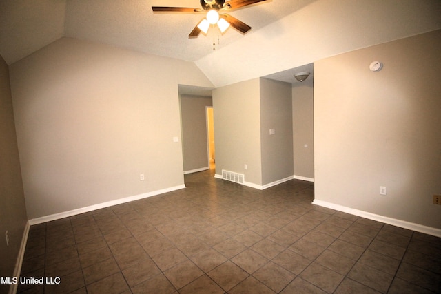 spare room featuring vaulted ceiling, baseboards, visible vents, and ceiling fan