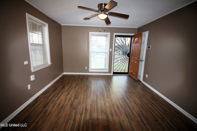 interior space featuring ceiling fan, baseboards, dark wood-style floors, and crown molding