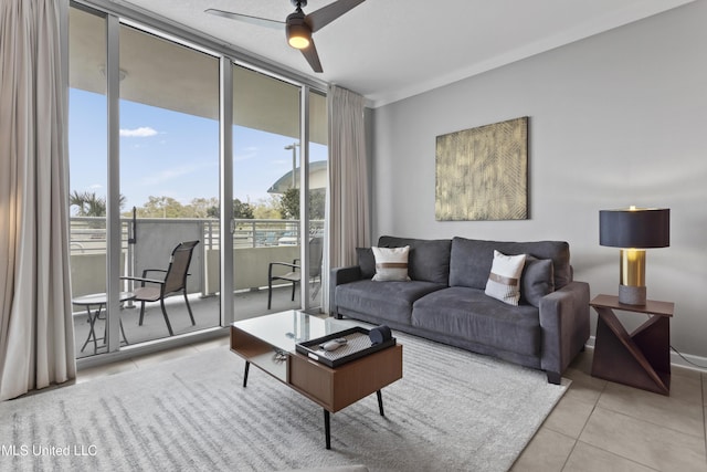2060 Beach Blvd Unit 102, Biloxi, MS 39531 - tiled living area with ceiling fan and a wall of windows