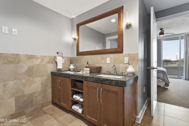 2060 Beach Blvd Unit 102, Biloxi, MS 39531 - ensuite bathroom with double vanity, tile patterned flooring, and tile walls