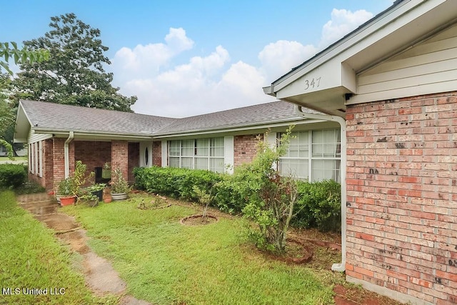 347 Rodenberg Ave, Biloxi, MS 39531 - view of front of home featuring brick siding, roof with shingles, and a front lawn