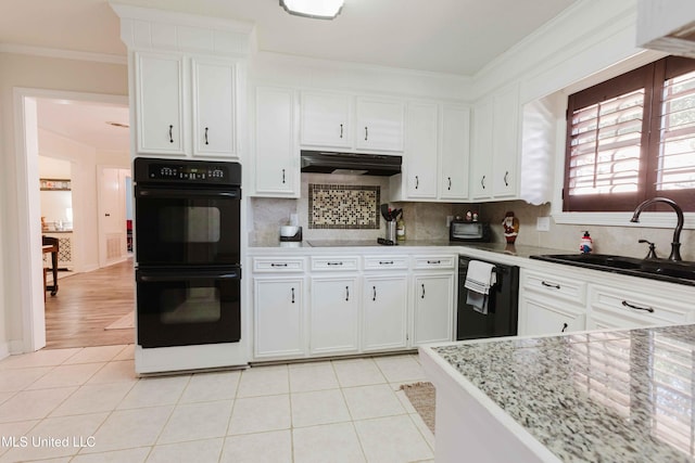 kitchen with white cabinetry, sink, light stone countertops, backsplash, and black appliances