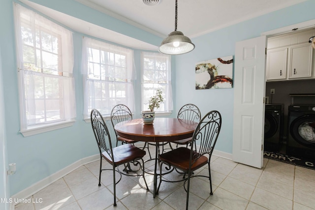 tiled dining area with washer and dryer