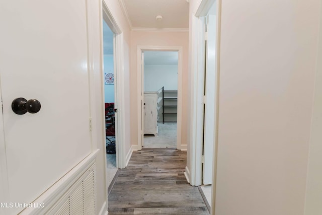 hall featuring wood-type flooring and ornamental molding