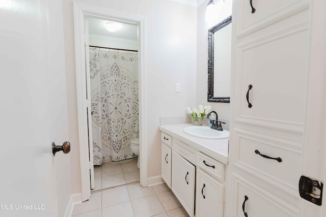 bathroom with tile patterned floors, vanity, toilet, and crown molding