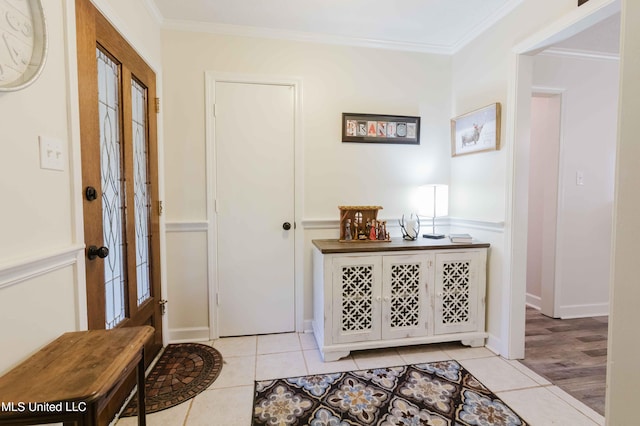 foyer with light wood-type flooring and ornamental molding