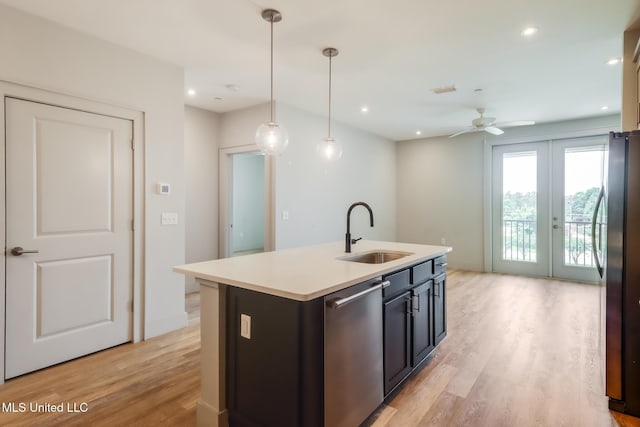 2501 Bienville Blvd Unit 334, Ocean Springs, MS 39564 - kitchen featuring a sink, stainless steel appliances, light wood-type flooring, a center island with sink, and a ceiling fan