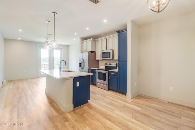 2501 Bienville Blvd Unit 334, Ocean Springs, MS 39564 - kitchen with appliances with stainless steel finishes, a sink, a center island with sink, light wood-style flooring, and recessed lighting