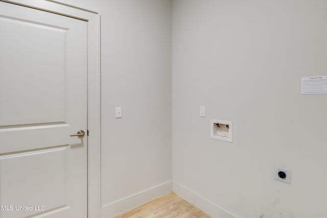 2501 Bienville Blvd Unit 334, Ocean Springs, MS 39564 - washroom with hookup for an electric dryer, washer hookup, light wood-style flooring, and baseboards