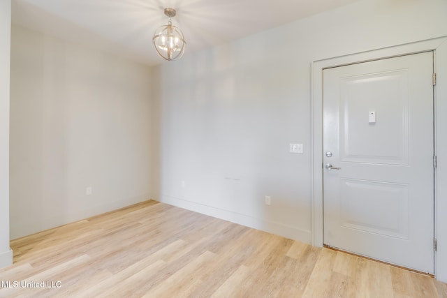 2501 Bienville Blvd Unit 334, Ocean Springs, MS 39564 - spare room with wood finished floors, a chandelier, and baseboards