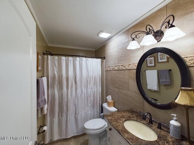 bathroom featuring crown molding, tile walls, toilet, vanity, and tile patterned floors