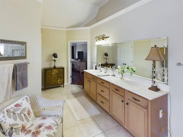 bathroom with double vanity, tile patterned flooring, vaulted ceiling, crown molding, and a sink