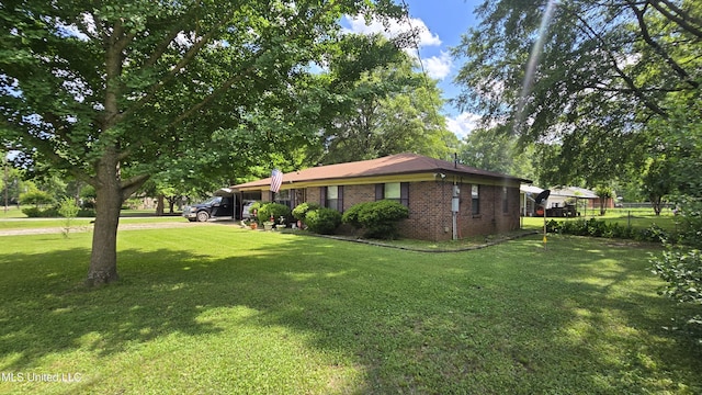 308 Walnut St, Benoit, MS 38725 - view of home's exterior with brick siding, an attached carport, and driveway