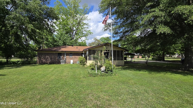 308 Walnut St, Benoit, MS 38725 - view of grassy yard with a sunroom and central air condition unit