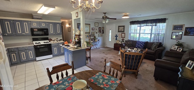 308 Walnut St, Benoit, MS 38725 - kitchen with gas range oven, black microwave, gray cabinets, crown molding, and open floor plan