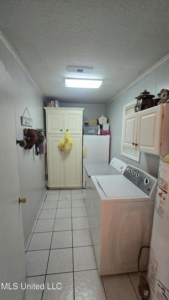 308 Walnut St, Benoit, MS 38725 - washroom with cabinet space, washing machine and clothes dryer, crown molding, gas water heater, and light tile patterned flooring