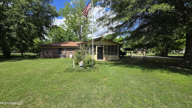 308 Walnut St, Benoit, MS 38725 - view of green lawn with a sunroom and central AC unit