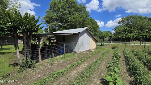308 Walnut St, Benoit, MS 38725 - view of side of home featuring metal roof and an outdoor structure