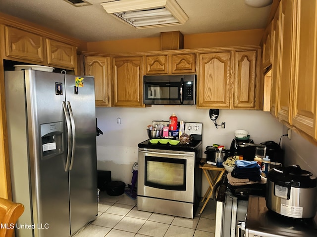 856 Saint Joseph St, Waveland, MS 39576 - kitchen with stainless steel appliances, light tile patterned floors, and brown cabinets