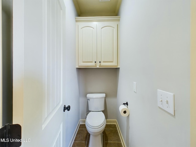 bathroom with toilet, tile patterned floors, and crown molding