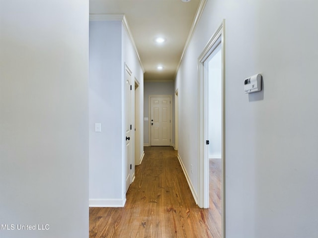 hall featuring ornamental molding and light hardwood / wood-style floors