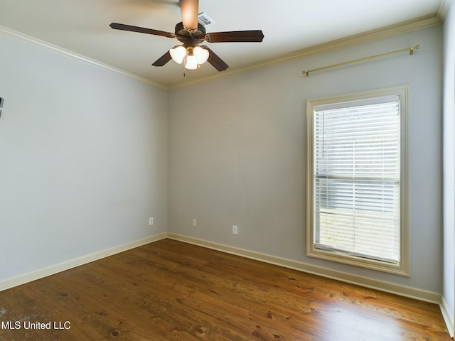 empty room with ceiling fan, crown molding, and hardwood / wood-style floors