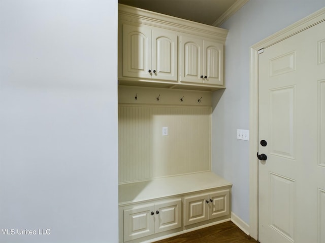 mudroom featuring dark wood-type flooring and ornamental molding