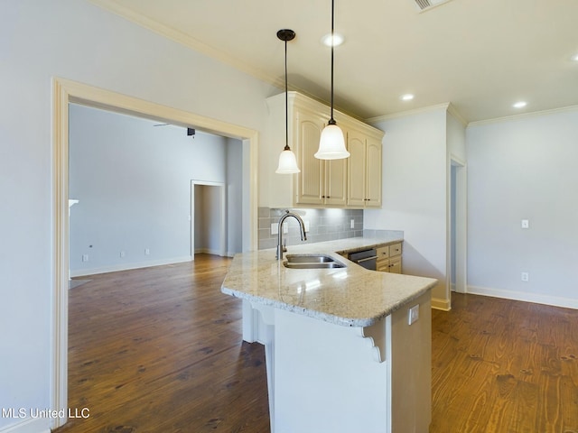 kitchen with backsplash, dark hardwood / wood-style flooring, pendant lighting, light stone counters, and sink