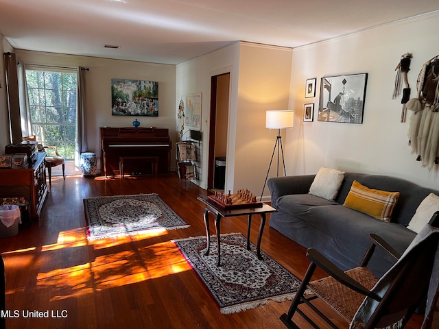 living room featuring dark hardwood / wood-style floors and ornamental molding